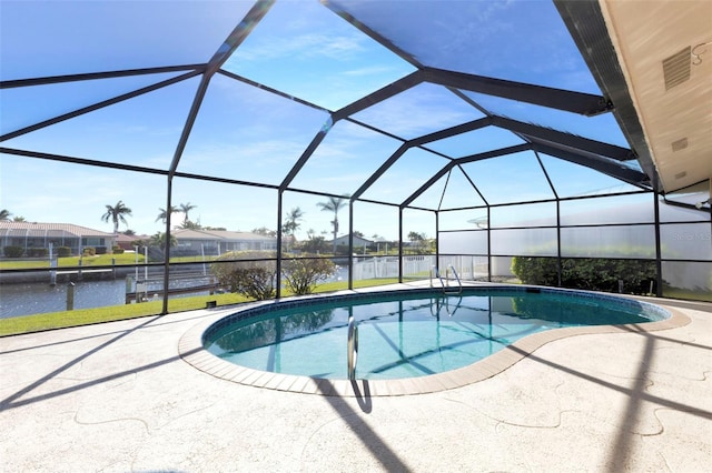 outdoor pool with a patio, a water view, and a lanai
