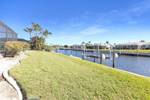 view of dock featuring a yard, boat lift, a water view, a residential view, and a lanai