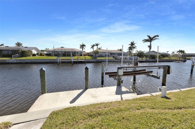 dock area featuring a water view, boat lift, and a residential view