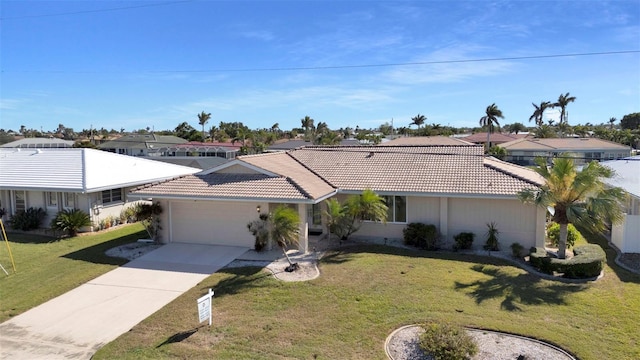 ranch-style home featuring a garage, concrete driveway, a tiled roof, a residential view, and a front yard