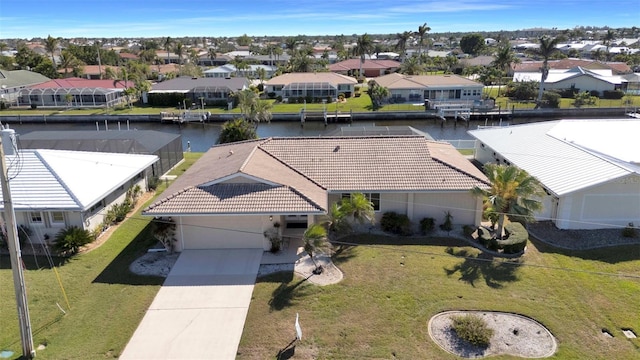 birds eye view of property featuring a water view and a residential view