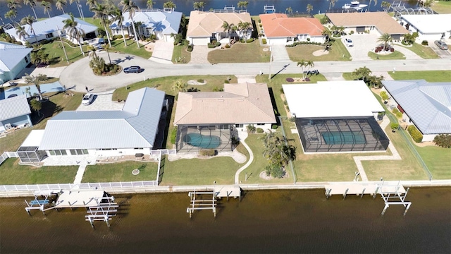drone / aerial view featuring a residential view and a water view
