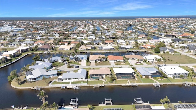 birds eye view of property featuring a water view and a residential view