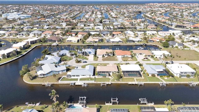 birds eye view of property featuring a water view and a residential view