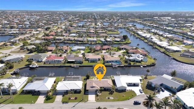 drone / aerial view featuring a residential view and a water view