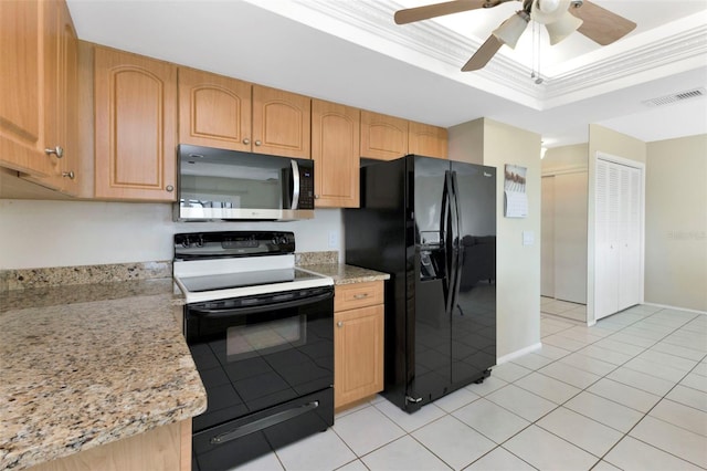 kitchen with light tile patterned floors, visible vents, ornamental molding, black appliances, and a tray ceiling