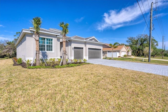 ranch-style house featuring a garage, a front yard, decorative driveway, and stucco siding