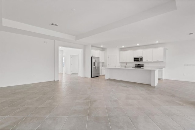 unfurnished living room featuring light tile patterned flooring, a sink, visible vents, and recessed lighting