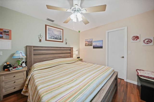 bedroom featuring baseboards, dark wood-style flooring, visible vents, and a ceiling fan