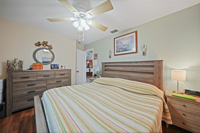 bedroom featuring dark wood-style floors, visible vents, and a ceiling fan