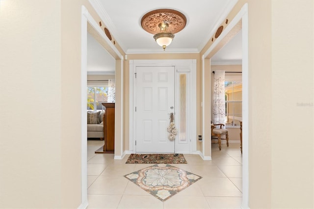 entrance foyer with crown molding, baseboards, and light tile patterned floors