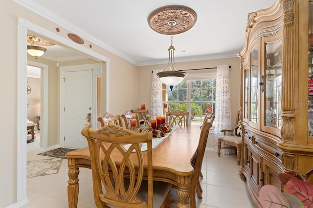 dining area with light tile patterned floors, baseboards, and crown molding