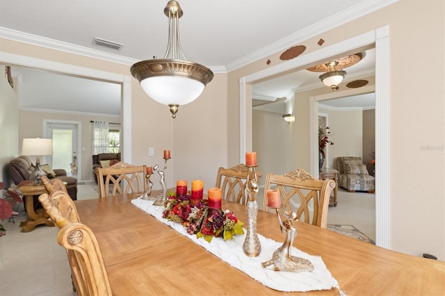 dining area with ornamental molding, tile patterned flooring, and visible vents