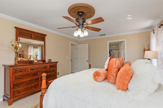 bedroom featuring light tile patterned floors, a ceiling fan, visible vents, and crown molding