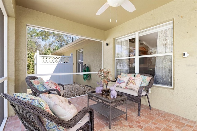 sunroom featuring ceiling fan