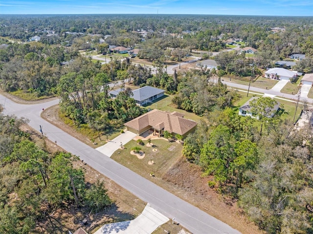 birds eye view of property featuring a forest view