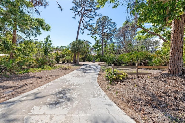 view of home's community featuring fence