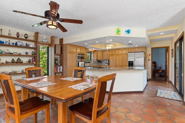 dining area featuring a ceiling fan, recessed lighting, and a textured ceiling