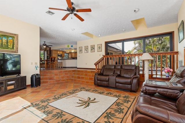 living area featuring ceiling fan, tile patterned flooring, visible vents, and baseboards