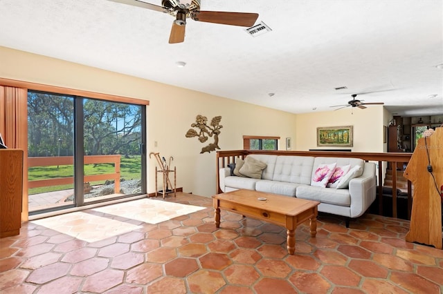 living room featuring ceiling fan and visible vents