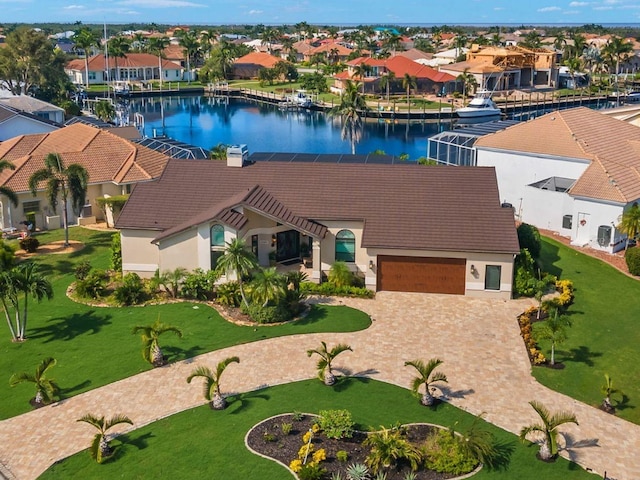 drone / aerial view featuring a residential view and a water view