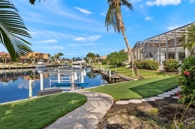 view of dock with a water view, boat lift, a residential view, and a lawn