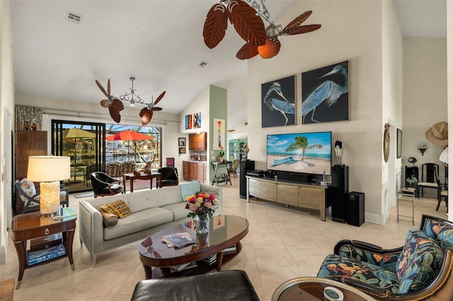 living area featuring high vaulted ceiling, light tile patterned floors, visible vents, and a ceiling fan