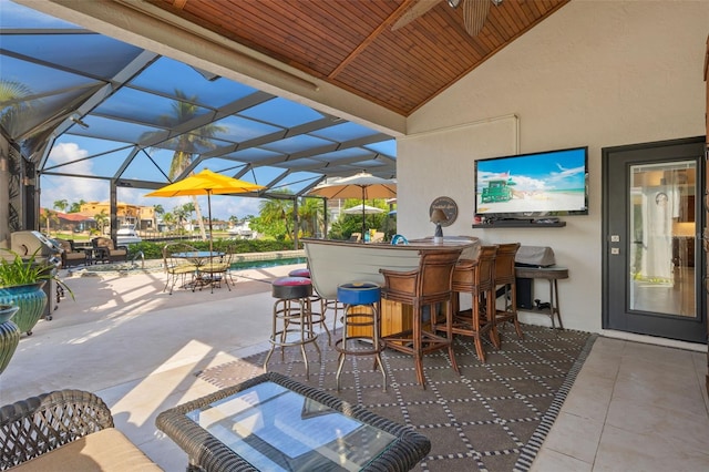 view of patio with a lanai and outdoor dry bar