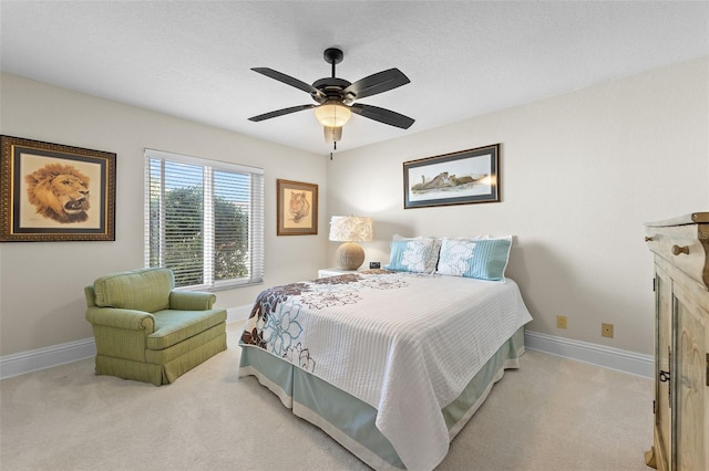 carpeted bedroom with a ceiling fan and baseboards