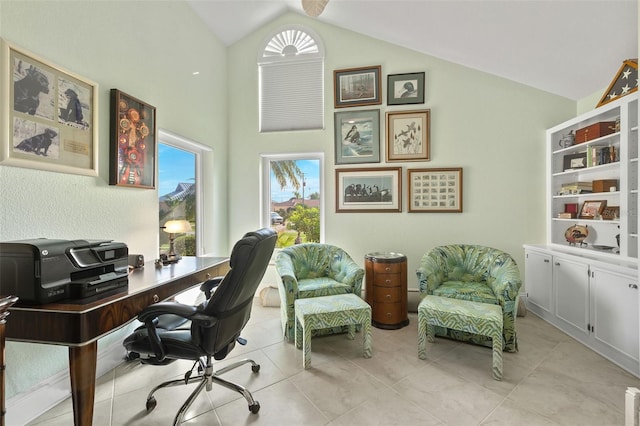 office area with vaulted ceiling and light tile patterned flooring