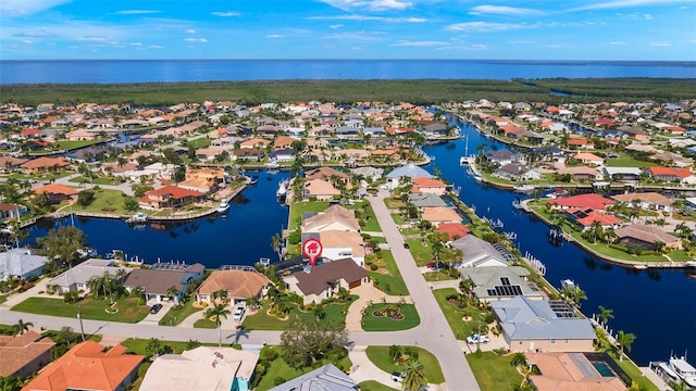 bird's eye view featuring a water view and a residential view