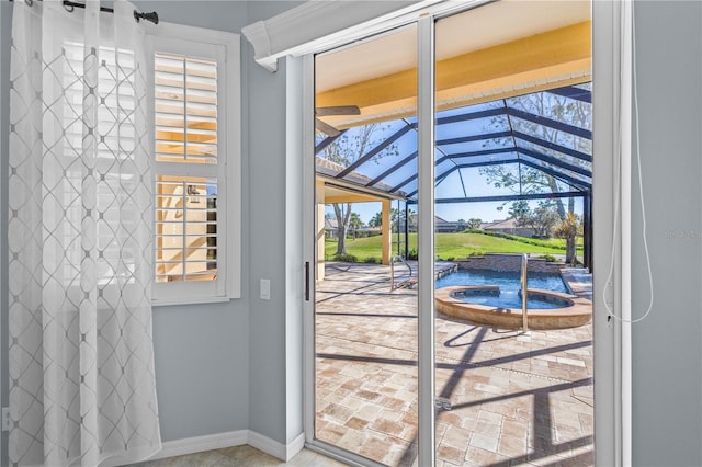 doorway to outside with a sunroom and baseboards