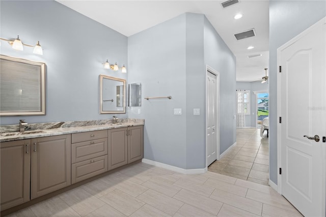 bathroom featuring visible vents, a sink, ensuite bath, and double vanity