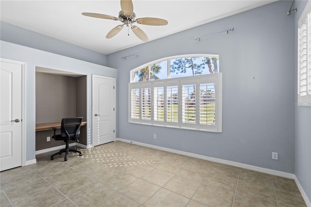 tiled home office with a ceiling fan and baseboards