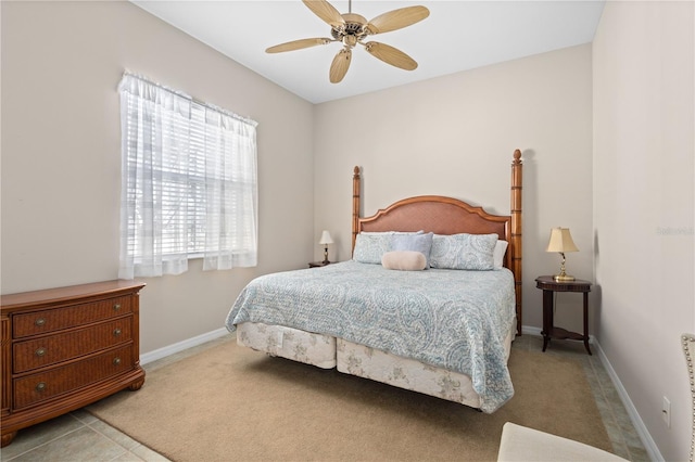 carpeted bedroom featuring ceiling fan and baseboards