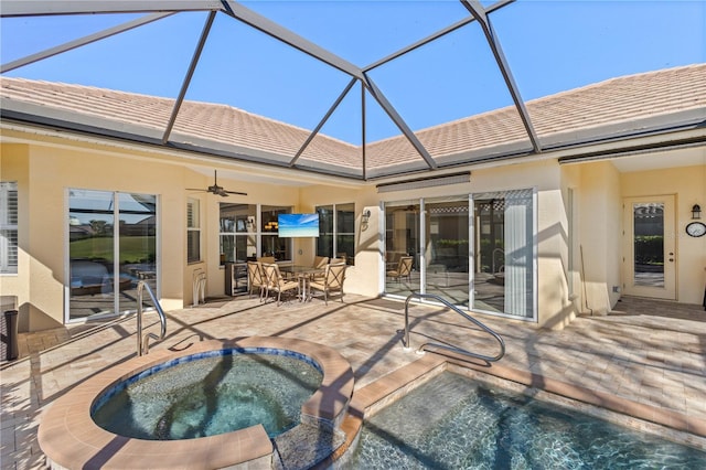 view of pool with a patio area, outdoor dining space, a ceiling fan, and an in ground hot tub