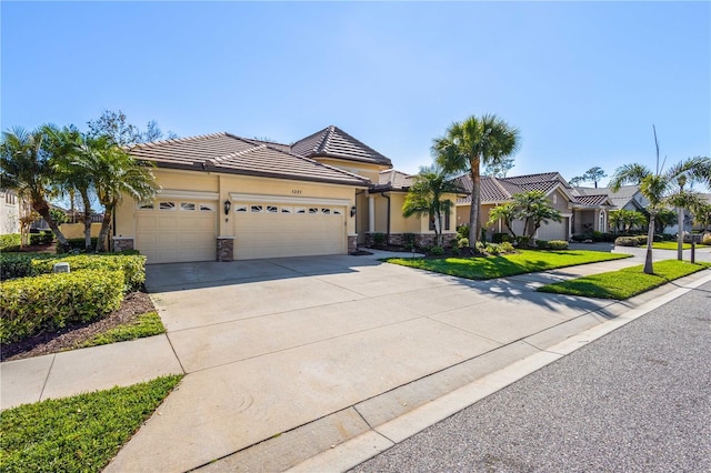 view of front facade with a garage, stone siding, concrete driveway, and stucco siding