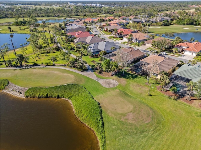 drone / aerial view featuring a residential view, a water view, and golf course view