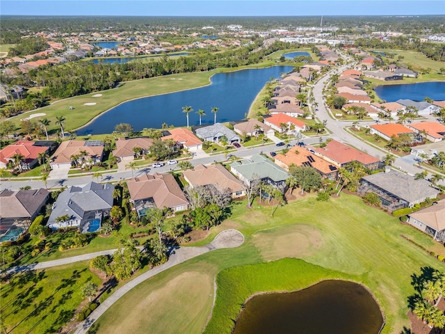 aerial view featuring golf course view, a water view, and a residential view