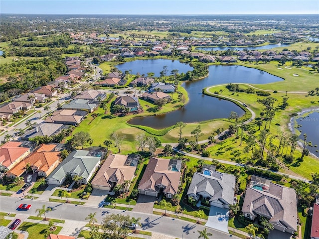 aerial view with golf course view, a water view, and a residential view