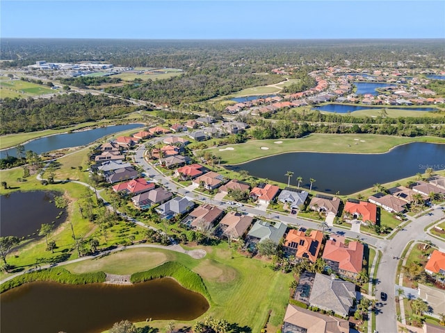 birds eye view of property featuring view of golf course, a water view, and a residential view