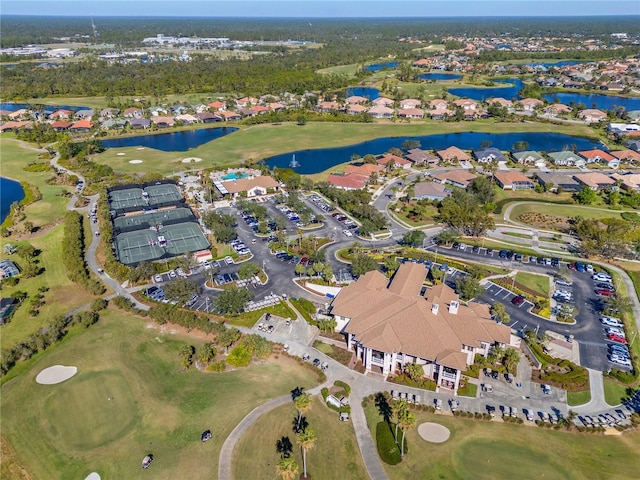 birds eye view of property with golf course view, a water view, and a residential view