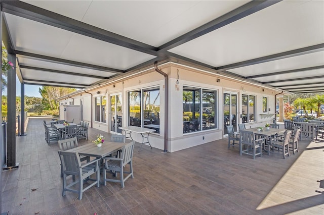 view of patio featuring outdoor dining space and a wooden deck