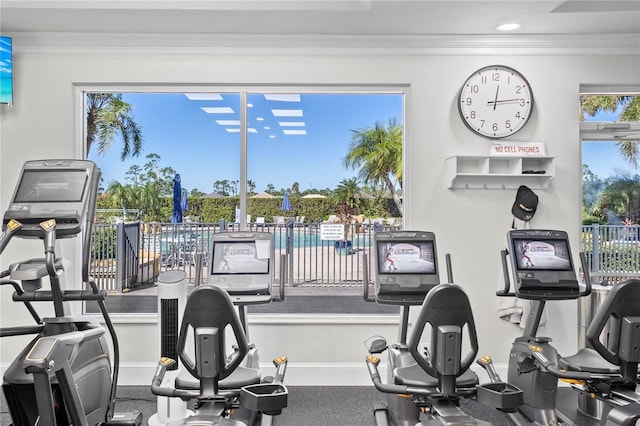 gym featuring ornamental molding and baseboards