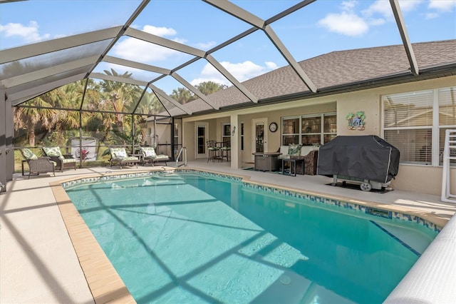 pool with glass enclosure, a patio, and area for grilling