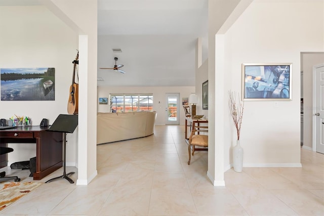 foyer with a ceiling fan, light tile patterned flooring, and baseboards