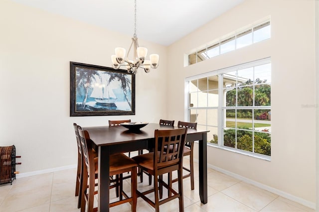 dining area with light tile patterned flooring, an inviting chandelier, and baseboards