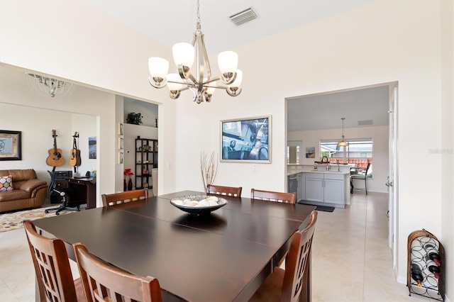 dining area featuring visible vents, a notable chandelier, and light tile patterned floors