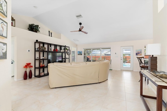 living room featuring visible vents, a ceiling fan, light tile patterned flooring, vaulted ceiling, and baseboards