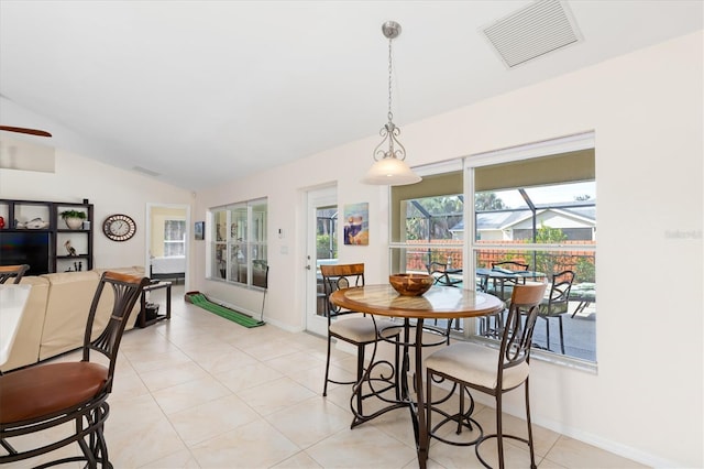 dining space featuring light tile patterned floors, lofted ceiling, visible vents, a sunroom, and a ceiling fan